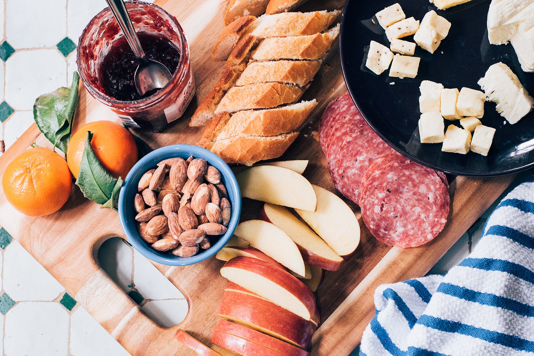 Charcuterie board with apples, cheese, nuts and meat.