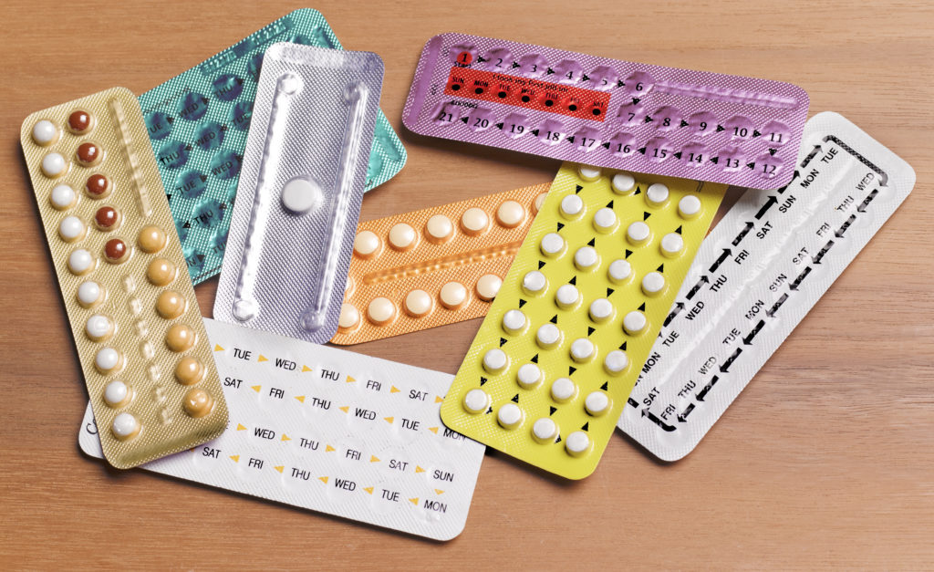 Image of various birth control pills in their blister packs